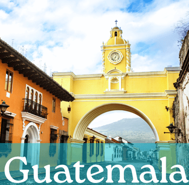 The yellow arch in Antigua with the word Guatemala written in white