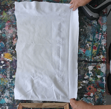 a person holding a piece of white fabric