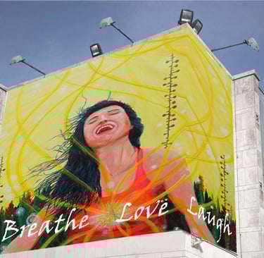 Mural of a joyful woman on a building with text saying Breathe Love Laugh.