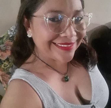 a woman with glasses and a cat sitting on a couch