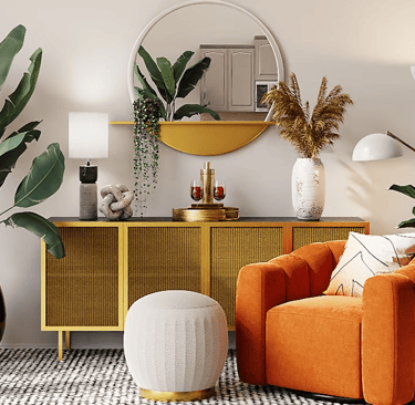 a living room with a couch, a table and a mirror