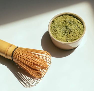 Close-up of vibrant green matcha powder and bamboo whisk
