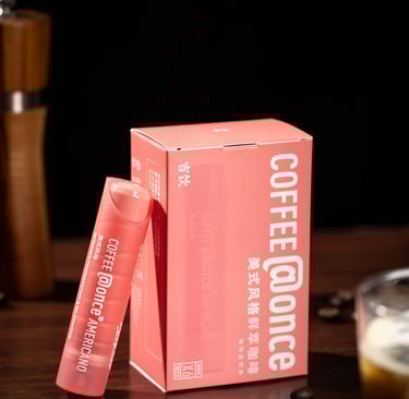 a pink box of coffee and a cup of coffee