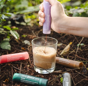 a person is holding a bottle of liquid in their hand