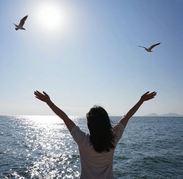 A black and white image capturing a live concert or worship event with people raising their hands. Stage lights and circular hanging structures are visible above the crowd. Text displayed on a large screen reads 'FOR HE ALONE IS WORTHY CHRIST THE LORD'.