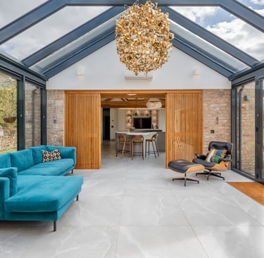 a stunning entrance hall with glass walls and ceiling and a chandelier