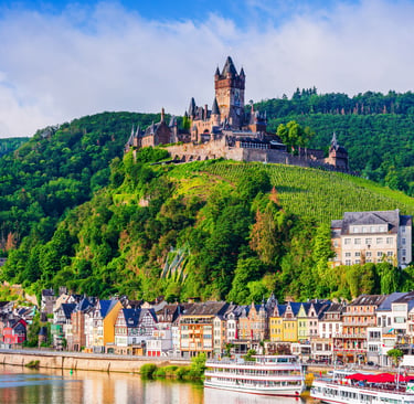 Cochem Imperial Castle overlooks the Moselle River and colorful medieval houses in Germany.