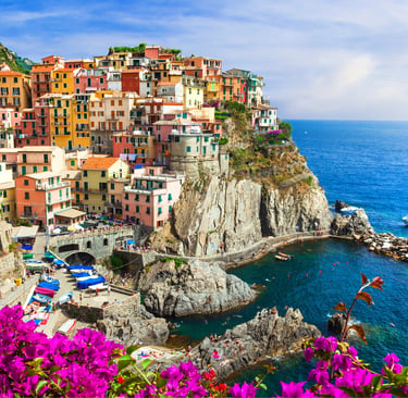 Colorful cliffside houses of Manarola in Cinque Terre Italy overlooking the Mediterranean Sea.