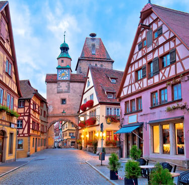 Colorful half-timbered houses along a cobblestone street in Rothenburg ob der Tauber, Germany.