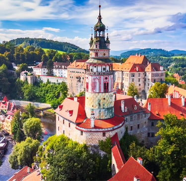 Aerial view of the historic State Castle and colorful round tower in Cesky Krumlov, Czech Republic.