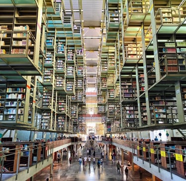 Modern Vasconcelos Library interior in Mexico City featuring suspended steel bookshelves and architectural symmetry.