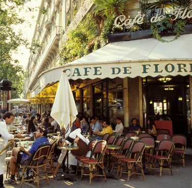 Waiters serve patrons at the outdoor seating of the iconic Cafe de Flore in Paris.