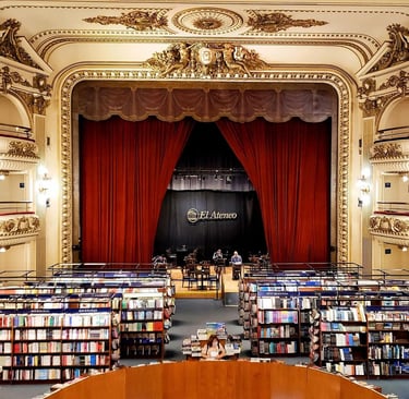 Inside El Ateneo Grand Splendid bookstore in Buenos Aires featuring theater balconies and red stage curtains.