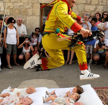 El Colacho jumping over babies during the traditional baby jumping festival in Castrillo de Murcia, Spain.