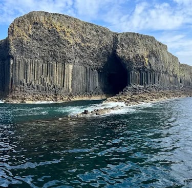 Fingal's Cave on the Isle of Staffa featuring dramatic basalt columns and sea cliffs in Scotland.