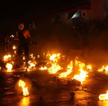 A person in a mask performs during Los Bolas de Fuego festival with flaming balls in Nejapa, El Salvador.