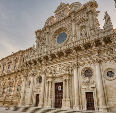 The ornate Baroque facade of Basilica di Santa Croce in Lecce, Italy, featuring intricate stone carvings.