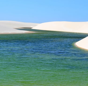 Turquoise freshwater lagoons between white sand dunes in Lencois Maranhenses National Park, Brazil.