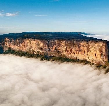 Aerial view of Mount Roraima's flat-topped sandstone tepui rising above a thick sea of clouds.