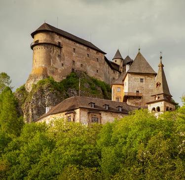Panoramic view of the historic Orava Castle perched on a high rock cliff in Oravsky Podzamok, Slovakia.