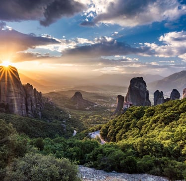 Golden sunset over the ancient Meteora monasteries and rock formations in Greece.