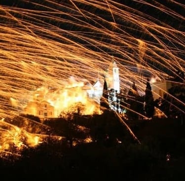 Rocket war fireworks light up the night sky over a church in Chios, Greece during Easter.