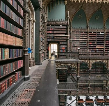 The ornate Royal Portuguese Cabinet of Reading in Rio de Janeiro featuring towering bookshelves and gothic architecture.
