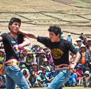 Peruvian men participate in a traditional Takanakuy fighting festival in the Andes mountains.