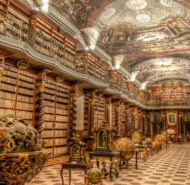 The historic Baroque Klementinum library in Prague featuring ornate bookshelves and ceiling frescoes.