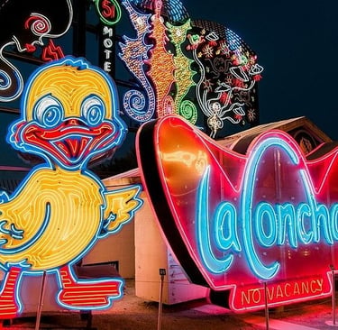 Vintage neon signs including a yellow duck and La Concha Motel sign at the Neon Museum in Las Vegas.
