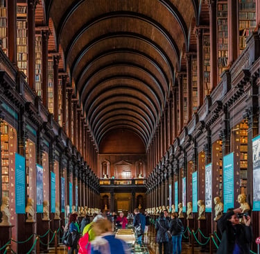 The Long Room at Trinity College Dublin's Old Library with vaulted ceilings and historic bookshelves.