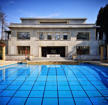 Villa Cavrois art deco architecture featuring a large blue outdoor swimming pool and limestone facade.