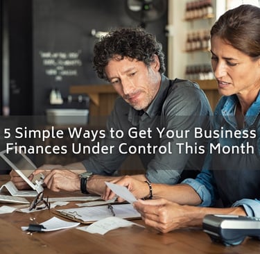 a man and woman sitting at a table with papers and papers