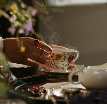 a person holding a cup of tea