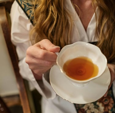woman holding cup of tea