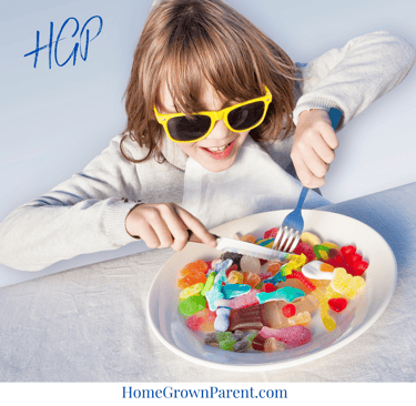 girl eating candy on a plate with a knife and fork