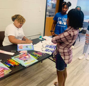 Tara Tucker signing copies of her book at a workshop.