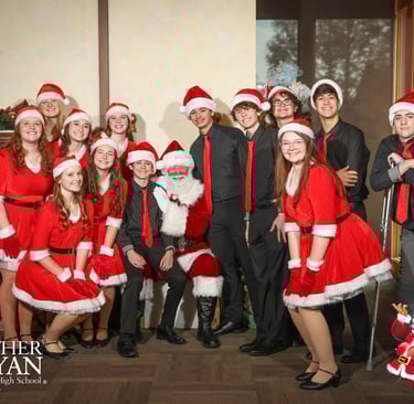 Santa Jay with a group of young people in Christmas garb.