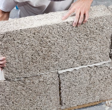 a man is putting a hemp block into a brick wall