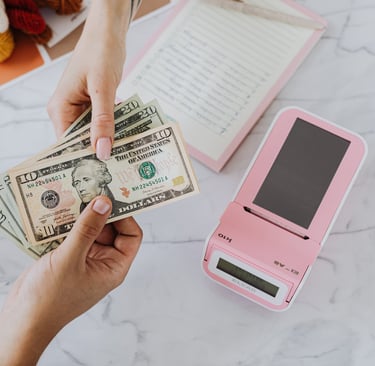 a person holding a stack of money and a cell phone
