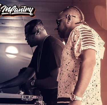 a man in a white shirt and sunglasses is playing with a dj