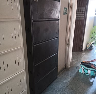 metal shoe rack cabinets with five compartments in a hallway