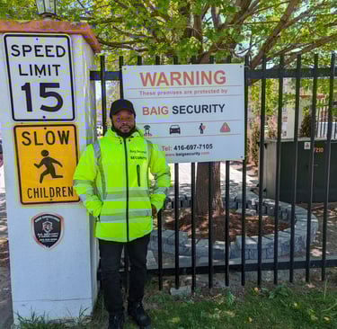 Male Security Guard standing outside the gate