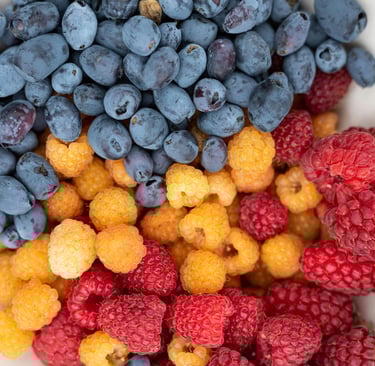 Gold and red raspberries with blueberries
