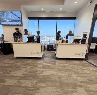 Friday Coffee mobile espresso bar setup in a modern office with baristas serving drinks