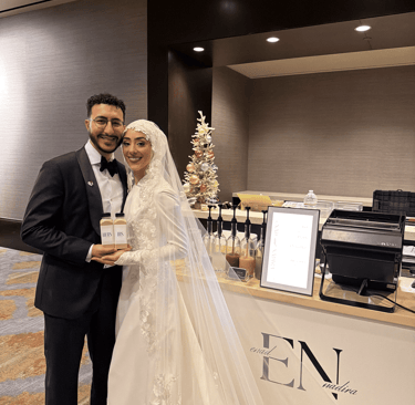 Bride and groom holding custom bottled coffee drinks at Dallas wedding with mobile coffee cart