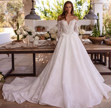 a woman in a wedding dress standing in front of a table