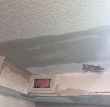 drywall ceiling with popcorn texture is being repaired a large patch