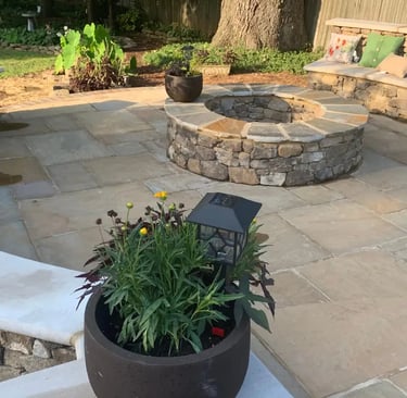 a concrete patio with a stone fire pit