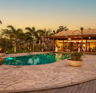 a pool with a stone concrete patio 
